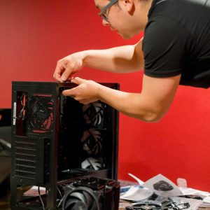 Man building a pc on a red basement